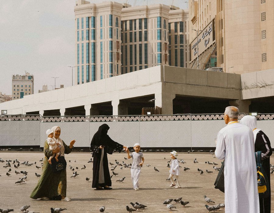 Family in abaya and kandura walking in a UAE public square