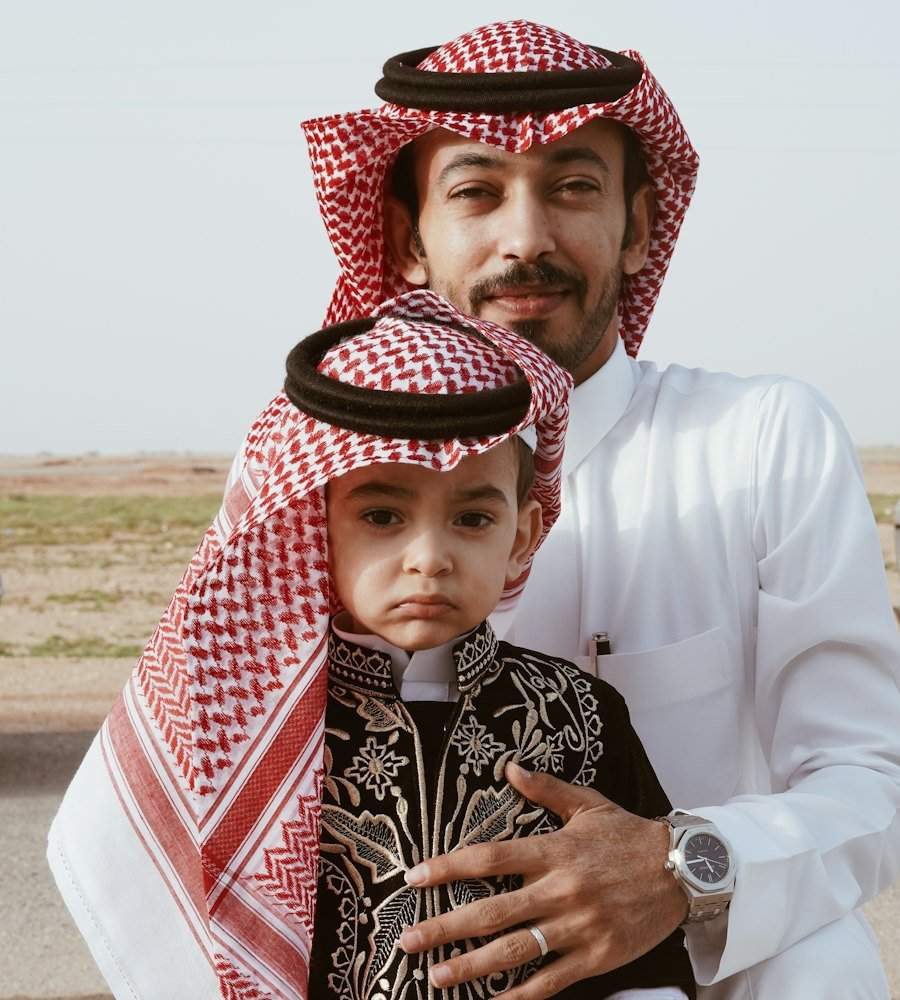 Father and son in traditional Emirati dress